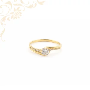 Különleges fazonú 14 karátos arany eljegyzési gyűrű hullámzó sínnel, központi cirkónia kővel és köves oldaldiszítéssel.